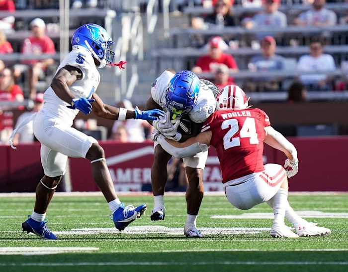 Wisconsin safety Hunter Wohler (24) tackles Buffalo running back Ron Cook Jr. (2) during the third quarter of the game on Saturday September 2, 2023 at Camp Randall Stadium in Madison, Wis.